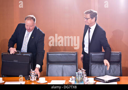 Berlin, Germany. 16th Oct, 2013. Out-going German Development Minister Dirk Niebel and out-going Foreign Minister Guido Westerwelle (R) arrive for the German cabinet meeting at the Federal Chancellery in Berlin, Germany, 16 October 2013. Photo: KAY NIETFELD/dpa/Alamy Live News Stock Photo