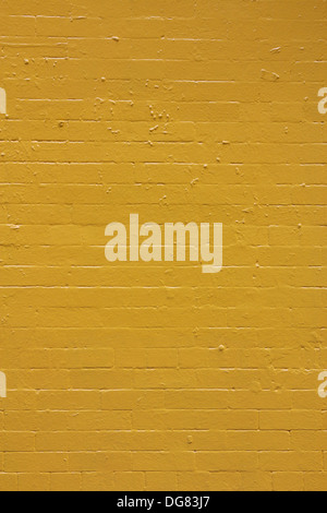 Yellow painted brick wall texture. Stock Photo
