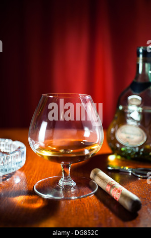 Brandy and cigars - A snifter glass of Hennessy XO Cognac with a large cigar Stock Photo