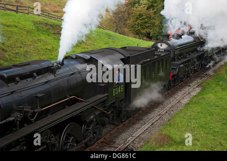 2 two vintage steam engines train trains loco locos locomotives leaving Goathland railway station NYMR North Yorkshire England UK United Kingdom GB Stock Photo