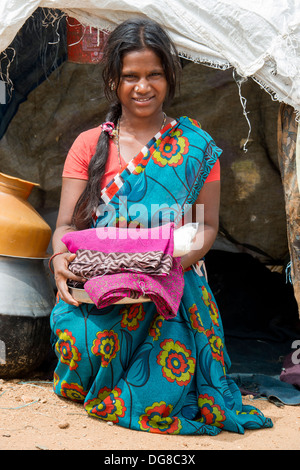 Lower caste Indian pregnant teenage girl with free food and clothes outside her bender / tent.  Andhra Pradesh, India Stock Photo