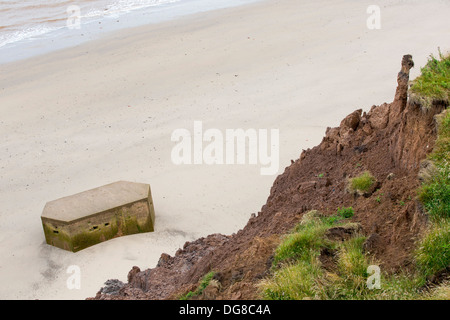 A Second world War Pill box on the beach near Aldbrough on Yorkshires East Coast, the fastest eroding coastline in Europe. Stock Photo