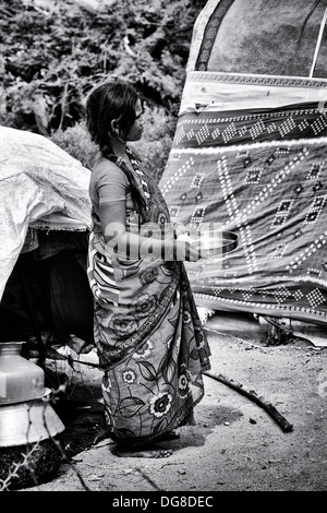 Lower caste Indian pregnant teenage girl waiting to receive free food and clothes outside her tented home. Andhra Pradesh, India Stock Photo