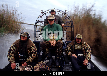 Duck hunters approaching their marsh blind in an airboat while