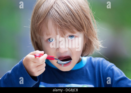 Boy with Blond Hair Eating Soup Stock Photo