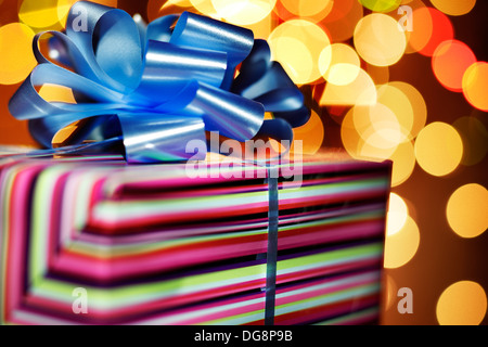 A couple of red, pink and turquoise blue presents tied with red bows on a white background Stock Photo