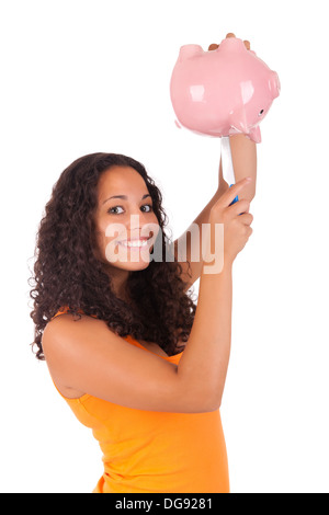 Young african american woman putting coin in piggy bank isolated Stock Photo