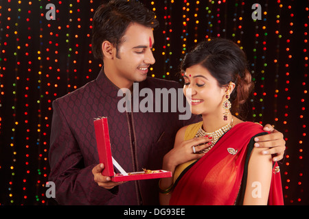 Indian man giving gift to woman on diwali Stock Photo