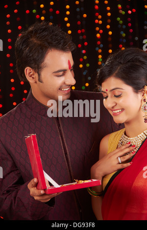 Indian man giving gift to woman on diwali Stock Photo