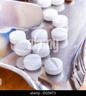 Close up of Counting tablets medical pills on stainless steel tray.(Health care and medical concept) Stock Photo