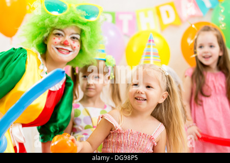 kids group and clown on birthday party Stock Photo