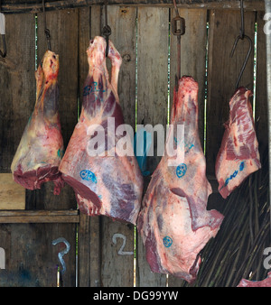 Madeira Portugal Beef hind quarters hanging in an outdoor farmers market Santo de serra Stock Photo
