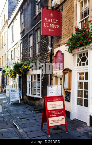 View down an old narrow side street in Bath with the famous Sally Lunn's tea house in the foreground. Stock Photo