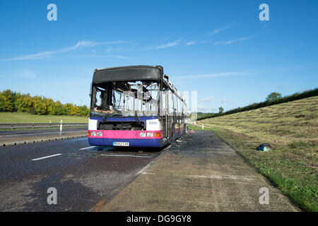 A130 Essex, UK. 17th Oct, 2013. Firefighters tackled a fire which saw a single decker bus catching light in the layby of the A130 between Howe Green and the Rettendon Turnpike. Wearing breathing apparatus and using two hose reel jets and one main jet firefighters  extinguished the blaze. No injuries were reported in the incident but long queues formed on the A130 back to the A12. Credit:  Allsorts Stock Photo/Alamy Live News Stock Photo