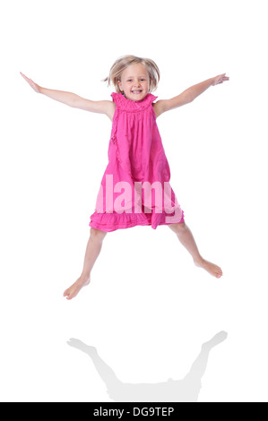 jumping girl in pink dress, isolated on white background Stock Photo