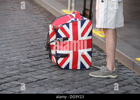 man with union jack flag trolley case bag in rome italy Stock Photo