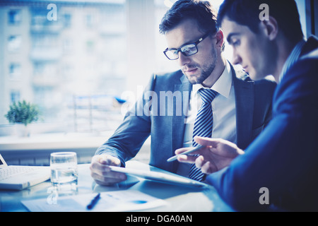 Image of two young businessmen discussing project at meeting Stock Photo