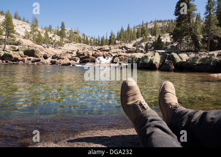 A basin of water with a mountain in the background at Tuolumne River in Yosemite National Park Stock Photo