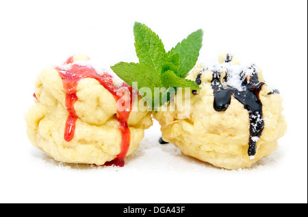 two eclairs decorated with mint sauce and a white background Stock Photo