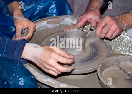 Close-up on potters hands making clay pottery Stock Photo