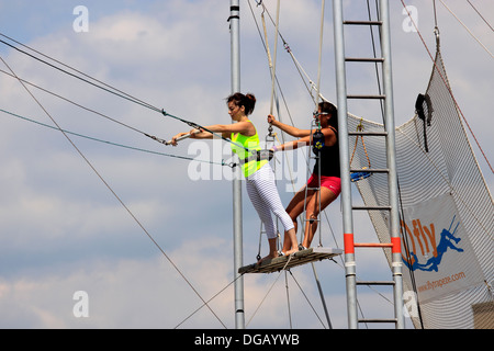 Woman practicing at trapeze school Long Beach Long Island New York Stock Photo