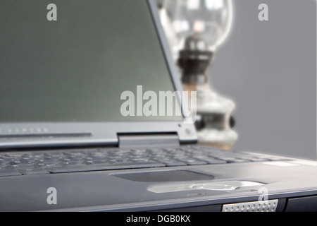 laptop and paraffin lamp in gray ambiance Stock Photo