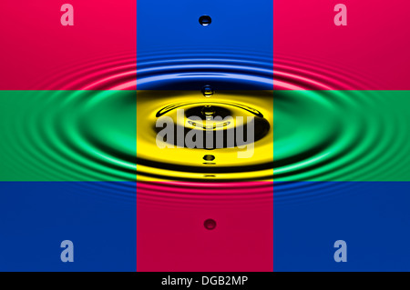 Colorful frames with water drops dripping into a pool of water creating ripples in the surface. Stock Photo