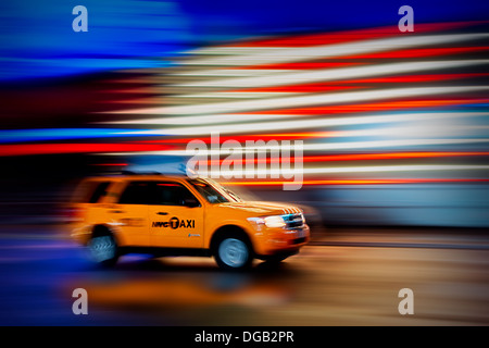 New York City Taxi whizzes along Times Square during the rain. Stock Photo