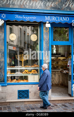 Man walks past Boulangerie Murciano - a Jewish bakery along Rue de Rosier in the Marais, Paris France Stock Photo
