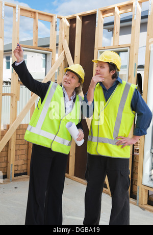 civil engineer and worker discussing issues at the construction site Stock Photo