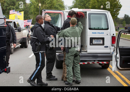 Man under arrest, being led to police van - Washington DC, USA Stock Photo