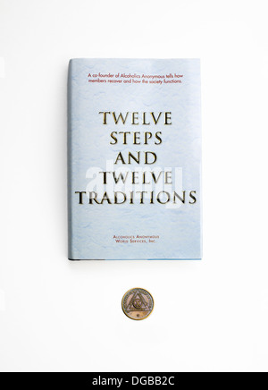 Alcoholics Anonymous AA Book 'The Twelve Steps and Twelve Traditions' with ten year coin Stock Photo