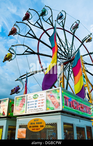 A carnival ticket booth and Farris Wheel ride in action at the Mountain State Fair in Asheville, North Carolina Stock Photo