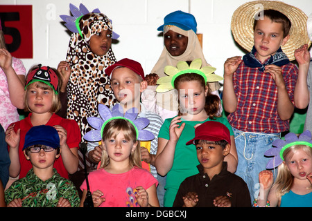 Racially mixed students age 8 singing and in costume for Spring Garden Musical. Horace Mann School St Paul Minnesota MN USA Stock Photo
