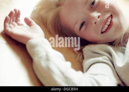Young girl lying on back, smiling Stock Photo