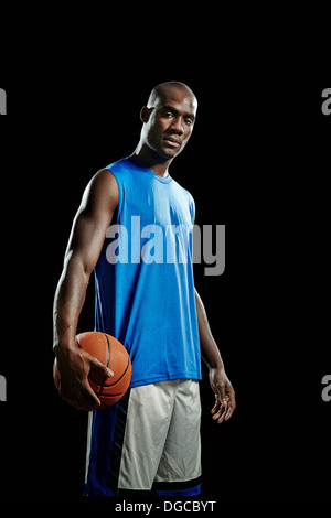 Studio portrait of basketball player with ball Stock Photo
