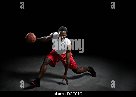 Studio shot of basketball player with ball Stock Photo