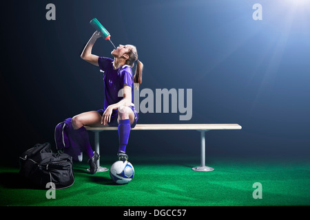 Female soccer player taking a break Stock Photo