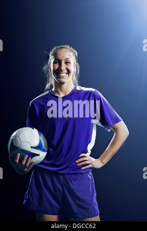 Studio shot of female soccer player with ball Stock Photo