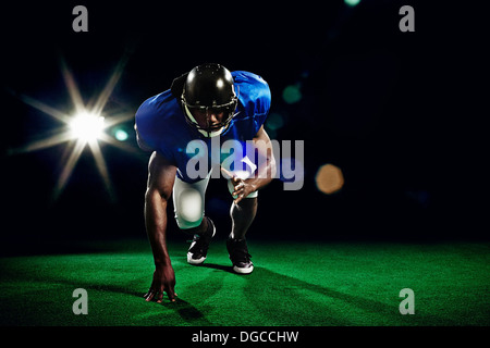 American football player crouching Stock Photo