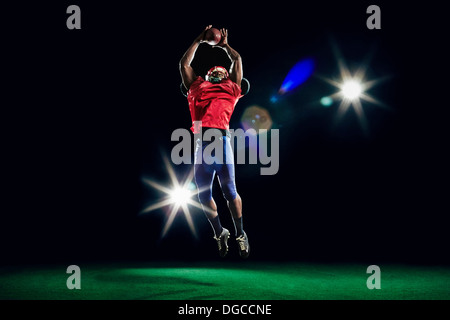 American football player catching ball Stock Photo