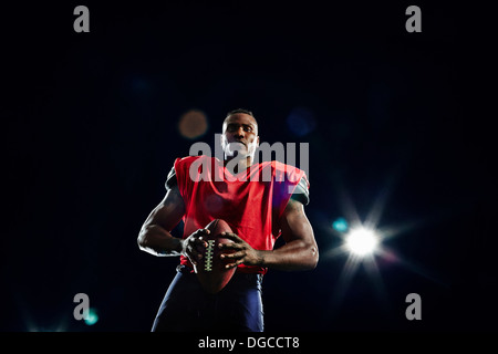 Portrait of american football player with ball Stock Photo