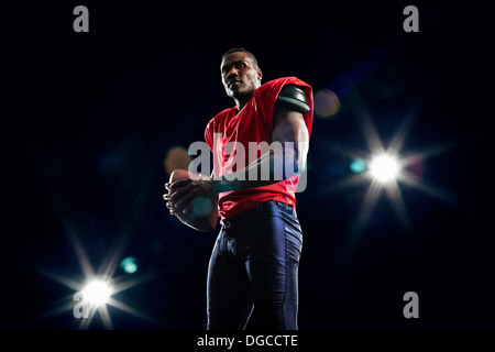 Portrait of american football player and ball Stock Photo