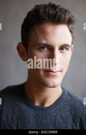 Young man smiling, studio shot Stock Photo
