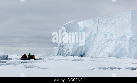 Boat approaching iceberg, ice floe in the southern ocean, 180 miles north of East Antarctica, Antarctica Stock Photo