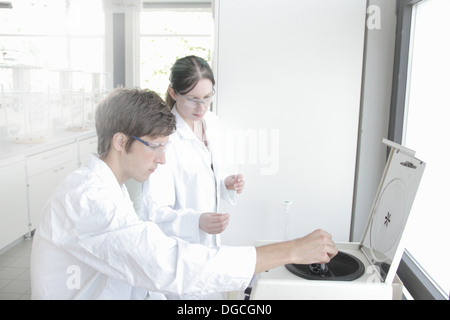 Chemistry students using equipment in laboratory Stock Photo