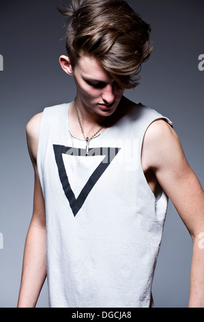 Young man looking down, studio shot Stock Photo