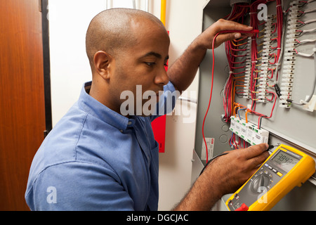 Mid adult electrical engineer working in manufacturing plant Stock Photo