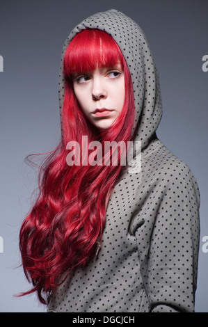 Young woman with long red hair in hooded top Stock Photo