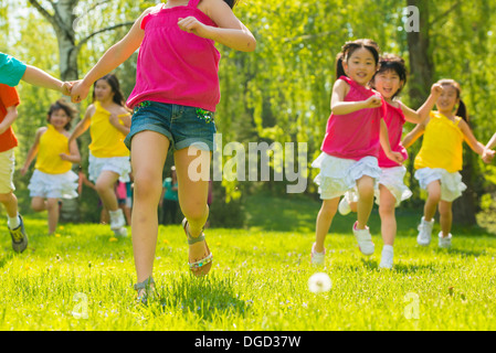 Children running on grass Stock Photo